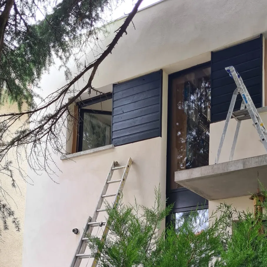 Façade de pavillon en cours de rénovation, échelles et volets anthracite